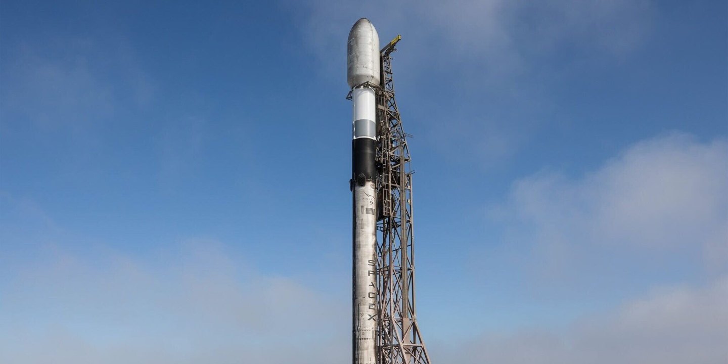 A launch vehicle on a pad beneath a blue sky